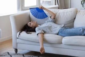 hot-woman-fanning-herself-on-couch